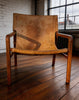 Tan leather sling armchair